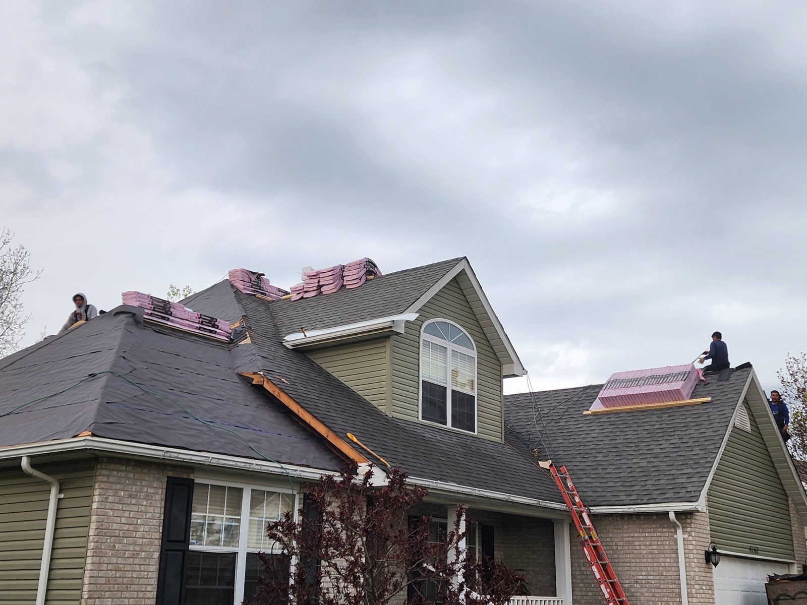 Shingle bundles staged on a roof during a full replacement